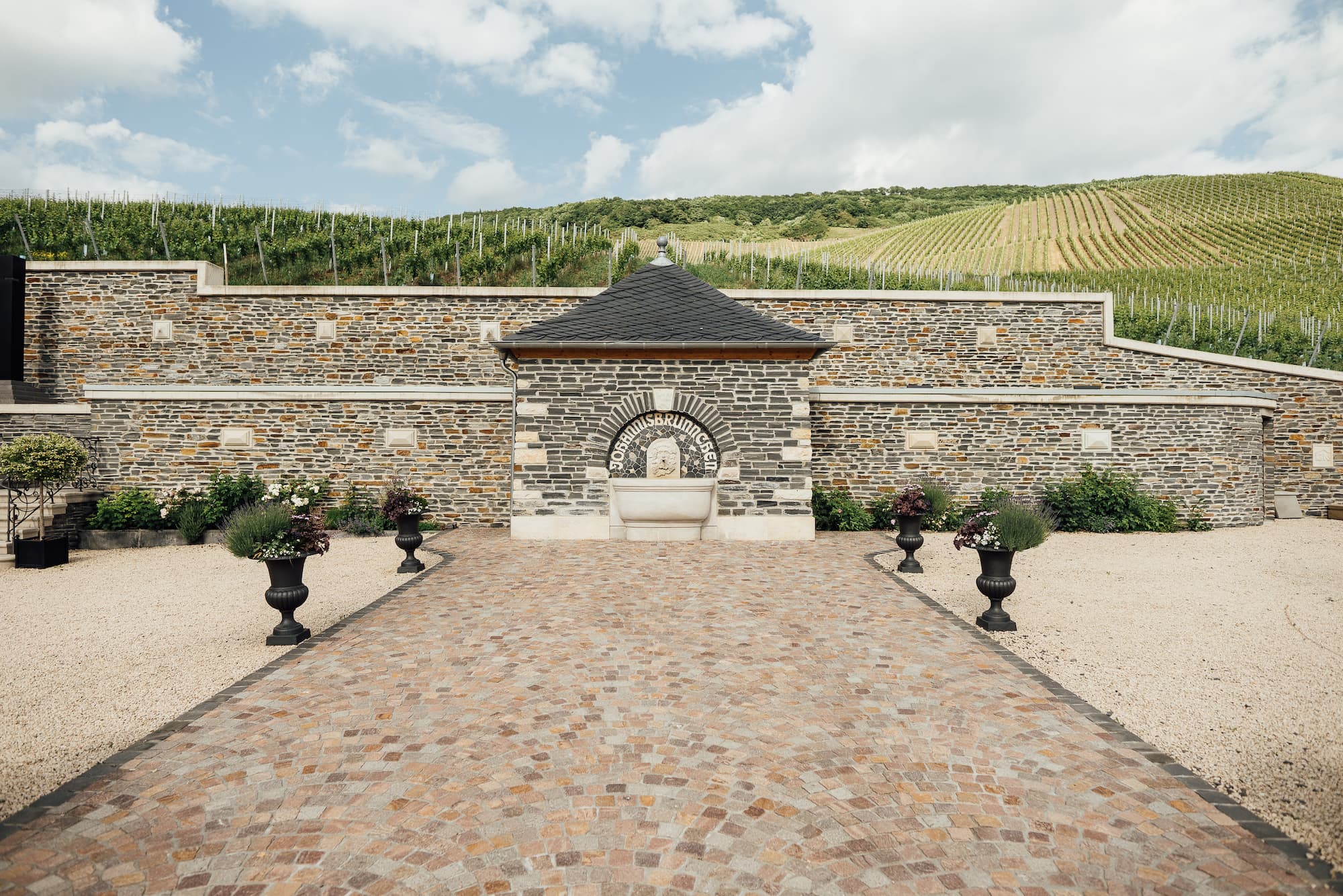 Blick von der historischen Villa des Weinguts Doktor Loosen und von einem Weinberg
